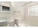 Bright bathroom with a pedestal sink, tiled shower, and clean finishes at 4010 Grove St, Denver, CO 80211