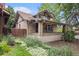 Charming brick home with a covered front porch and mature landscaping at 4010 Grove St, Denver, CO 80211
