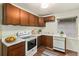 Functional kitchen with wood cabinets, practical appliances, and natural light at 4010 Grove St, Denver, CO 80211