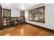 Bright living room featuring a brick fireplace, hardwood floors, and original woodwork at 4010 Grove St, Denver, CO 80211