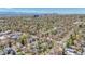 A panoramic aerial shot of a suburban landscape with lush greenery and the city skyline in the background at 1027 S University Blvd, Denver, CO 80209