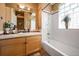 Bright bathroom with a soaking tub, white tile, and a vanity with ample storage at 1027 S University Blvd, Denver, CO 80209