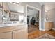 Well-lit bathroom with a large mirror, vanity, and hardwood floors, creating a welcoming space at 1027 S University Blvd, Denver, CO 80209
