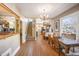 Charming dining room with wood floors, chandelier, and large windows providing natural light at 1027 S University Blvd, Denver, CO 80209