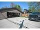 Two-car garage and large driveway for easy parking and access to home, with vehicle inside at 1027 S University Blvd, Denver, CO 80209
