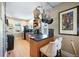 Well-lit kitchen with hardwood floors, stainless steel appliances, and a convenient breakfast bar at 1027 S University Blvd, Denver, CO 80209