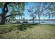 View of a park by the water with lush green grass, picnic tables, and mature trees under a sunny sky at 1027 S University Blvd, Denver, CO 80209