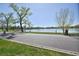 Scenic lakeside view with trees, green grass, blue skies, and a walking path along the water's edge at 1027 S University Blvd, Denver, CO 80209