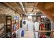 Utility basement features a laundry area with washer, dryer, and storage shelves for convenience at 1027 S University Blvd, Denver, CO 80209