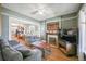 Comfortable living room with hardwood floors, a cozy fireplace, and ample seating at 1027 S University Blvd, Denver, CO 80209