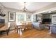Open-concept living and dining area with hardwood floors and stylish decor at 1027 S University Blvd, Denver, CO 80209