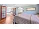 Stylish main bedroom with hardwood floors leading to an ensuite bathroom, creating a private retreat at 1027 S University Blvd, Denver, CO 80209