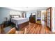 Spacious main bedroom features hardwood floors, a walk-in closet, and a soothing color palette at 1027 S University Blvd, Denver, CO 80209