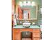 Eclectic bathroom featuring a unique vanity with a vessel sink and a brick accent wall at 3249 W Fairview Pl # 106, Denver, CO 80211