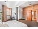 Bedroom featuring exposed brick, curved ceiling, large windows, and modern furniture at 3249 W Fairview Pl # 106, Denver, CO 80211