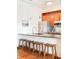 Stylish kitchen with wooden stools, granite countertops, stainless appliances, and blue pendant lighting at 3249 W Fairview Pl # 106, Denver, CO 80211