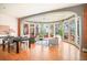 Open floor plan combining the living and dining areas, featuring large windows and hardwood floors at 3249 W Fairview Pl # 106, Denver, CO 80211