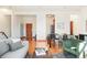 Spacious living area seamlessly connects to the dining space, boasting hardwood floors and natural light at 3249 W Fairview Pl # 106, Denver, CO 80211