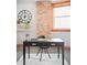Bright office space with exposed brick, modern desk, and ample natural light at 3249 W Fairview Pl # 106, Denver, CO 80211