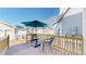 Cozy back deck with an umbrella and seating area for enjoying the outdoors at 4523 Crestone Peak St, Brighton, CO 80601