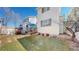 Private backyard featuring a deck with seating, manicured lawn, and a white picket fence at 4523 Crestone Peak St, Brighton, CO 80601