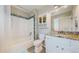 Bathroom featuring a granite countertop, decorative tile backsplash, and white fixtures at 4523 Crestone Peak St, Brighton, CO 80601