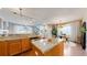 Bright open kitchen with granite counters and an island flowing into the dining and living spaces at 4523 Crestone Peak St, Brighton, CO 80601