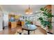 Open kitchen with wood cabinets and granite counters flowing into the living room with stylish furnishings at 4523 Crestone Peak St, Brighton, CO 80601