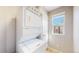 Efficient laundry area with stacked washer and dryer and a window for natural light, maximizing space and functionality at 4523 Crestone Peak St, Brighton, CO 80601