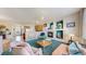 Inviting living room featuring a cozy fireplace, stylish decor, and an open layout into the kitchen at 4523 Crestone Peak St, Brighton, CO 80601