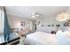 Bright main bedroom with an ensuite bathroom, large bed, and statement lighting at 4523 Crestone Peak St, Brighton, CO 80601