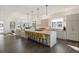 Modern kitchen with large island, quartz countertops, and stainless steel appliances at 5191 Copper Blush Ct, Castle Rock, CO 80108