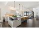 Modern kitchen with large island and breakfast bar, and access to the patio at 5191 Copper Blush Ct, Castle Rock, CO 80108