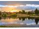 Upscale homes surround a serene lake at sunset at 5191 Copper Blush Ct, Castle Rock, CO 80108