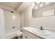 Bright bathroom featuring a shower-tub combo and white vanity with modern lighting at 3082 S Wheeling Way # 203, Aurora, CO 80014