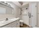 Bathroom with a walk-in shower, vanity, and white fixtures at 3082 S Wheeling Way # 203, Aurora, CO 80014