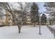 Well maintained building with mature trees on snow-covered ground in a residential area at 3082 S Wheeling Way # 203, Aurora, CO 80014