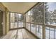 Enclosed sunroom with large windows offering natural light and views of snow-covered trees at 3082 S Wheeling Way # 203, Aurora, CO 80014