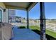 Back porch with stone pillars overlooks yard with fence, artificial grass and beautiful views at 5837 High Timber Cir, Castle Rock, CO 80104