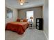Cozy bedroom with orange bedding, soft carpet, bedside table, and a cute floral painting at 5837 High Timber Cir, Castle Rock, CO 80104