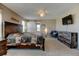 Spacious main bedroom with a ceiling fan, TV, sliding barn door, and carpeted floors at 5837 High Timber Cir, Castle Rock, CO 80104