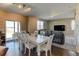 Sunlit dining area with white table and chairs, seamlessly connecting to the outdoor patio via sliding glass doors at 5837 High Timber Cir, Castle Rock, CO 80104