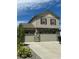 Two-story home featuring a three-car garage, stone accents, and red window shutters at 5837 High Timber Cir, Castle Rock, CO 80104
