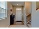 Bright foyer with hardwood flooring, a staircase, and a convenient storage unit at 5837 High Timber Cir, Castle Rock, CO 80104