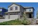 Charming two-story home featuring stone accents, a three-car garage, and a well-manicured front yard at 5837 High Timber Cir, Castle Rock, CO 80104