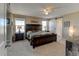 Bright main bedroom featuring a dark wood bed frame, side tables, and a rustic sliding barn door at 5837 High Timber Cir, Castle Rock, CO 80104