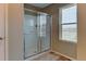 Glass enclosed shower with white tile, and a window for natural light at 5837 High Timber Cir, Castle Rock, CO 80104