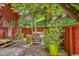 Relaxing backyard patio features a dining table, lounge chair and is surrounded by lots of greenery at 23626 Genesee Village Rd, Golden, CO 80401