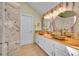 Modern bathroom featuring dual vessel sinks, wood countertop, elegant lighting and unique decorative mirrors at 23626 Genesee Village Rd, Golden, CO 80401