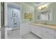 Classic bathroom features wainscoting, a vanity, and a separate toilet room at 23626 Genesee Village Rd, Golden, CO 80401